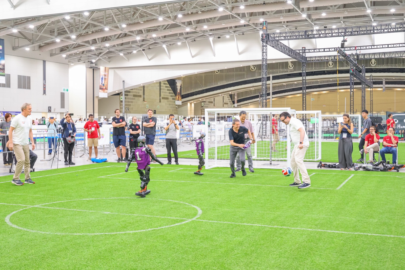 RoboCup trustees playing a cascarita against humanoid robots, Incheon 2026